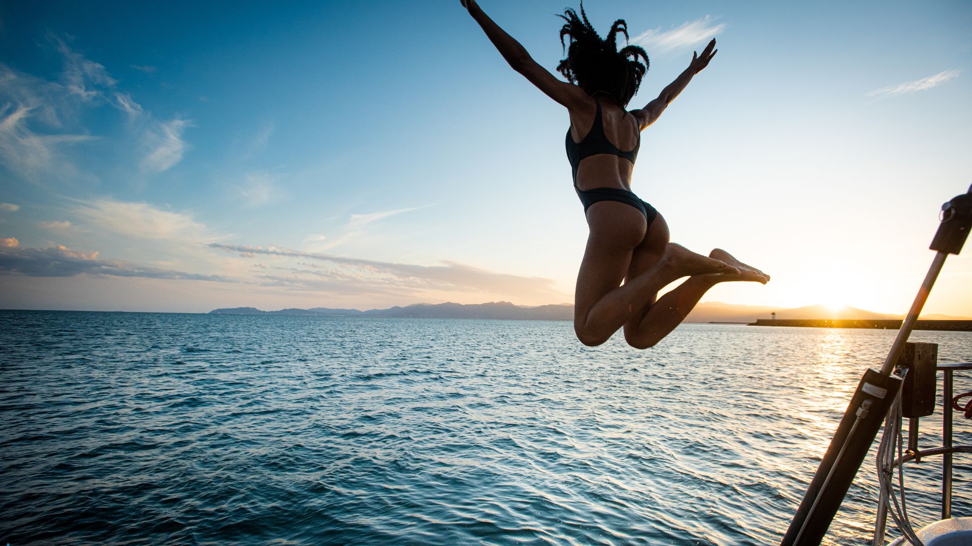 woman jumping from boat